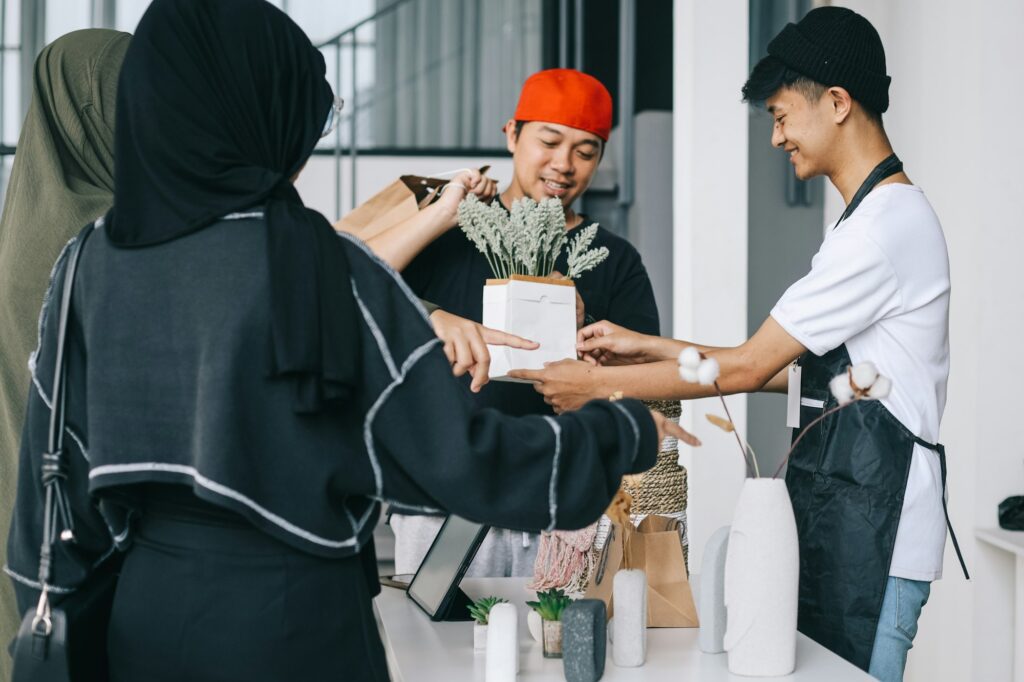 Penjual dan pembeli berinteraksi di toko sebagai hasil dari riset pasar sebelum memulai bisnis